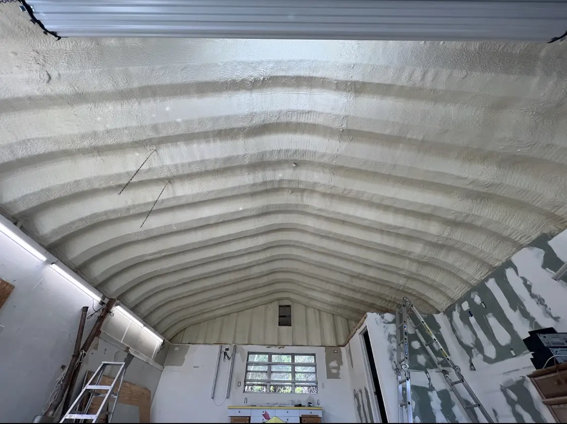 Spray polyurethane foam applied to the underside of a metal roof deck in Southbridge Town